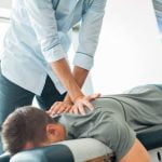 chiropractor helping back pain and sciatic